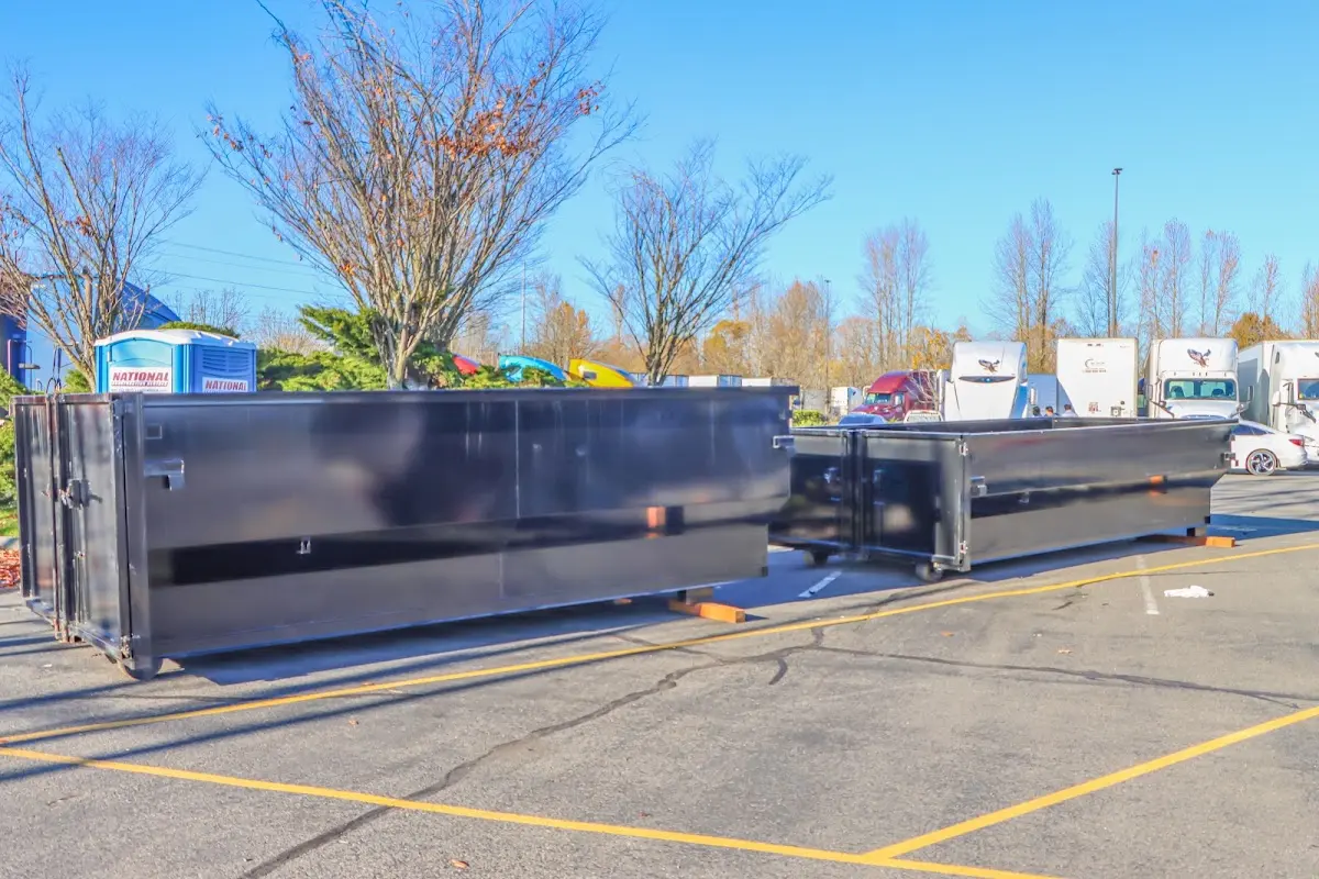 Professional dumpster rental service with roll-off container on residential driveway in Beaver Dam